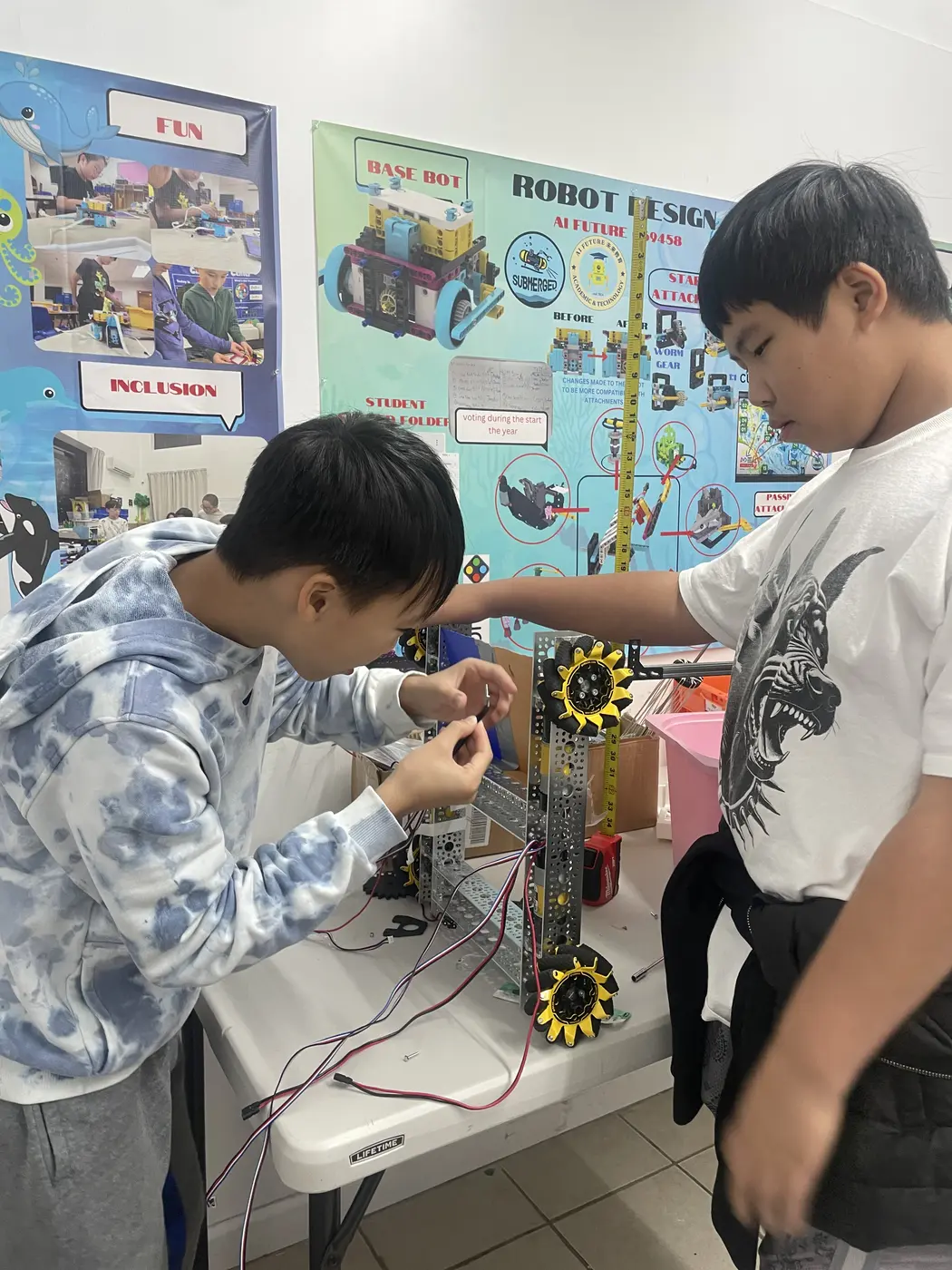 Two team members building a mechanism with sprockets