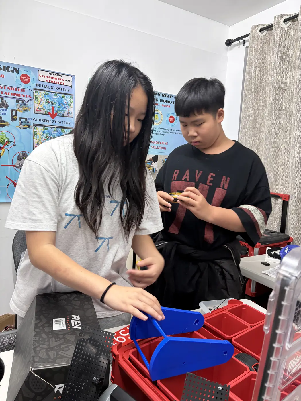 Two team members sorting parts